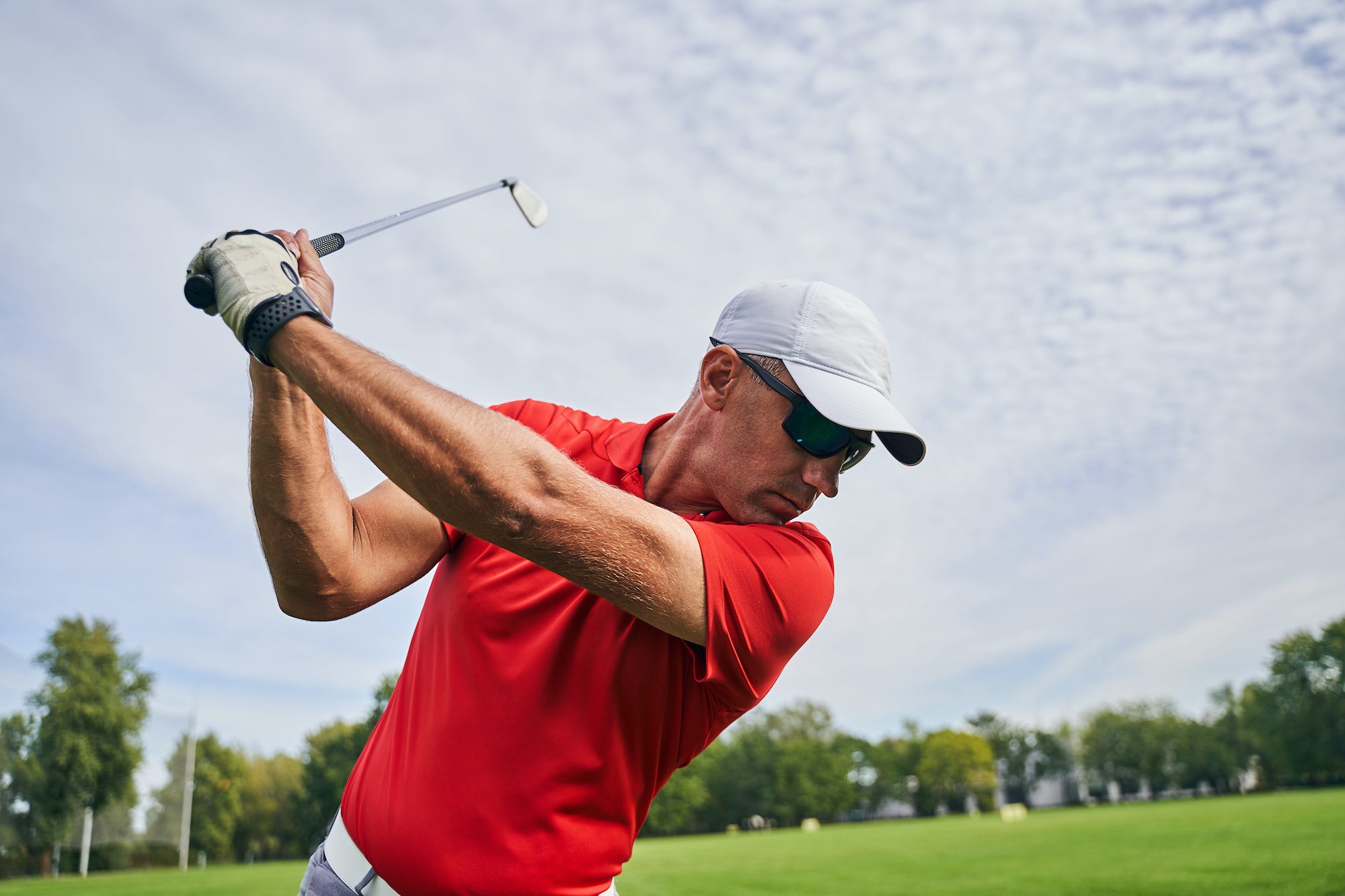 Male golfer doing a golf swing outdoors Male golfer doing a golf swing outdoors